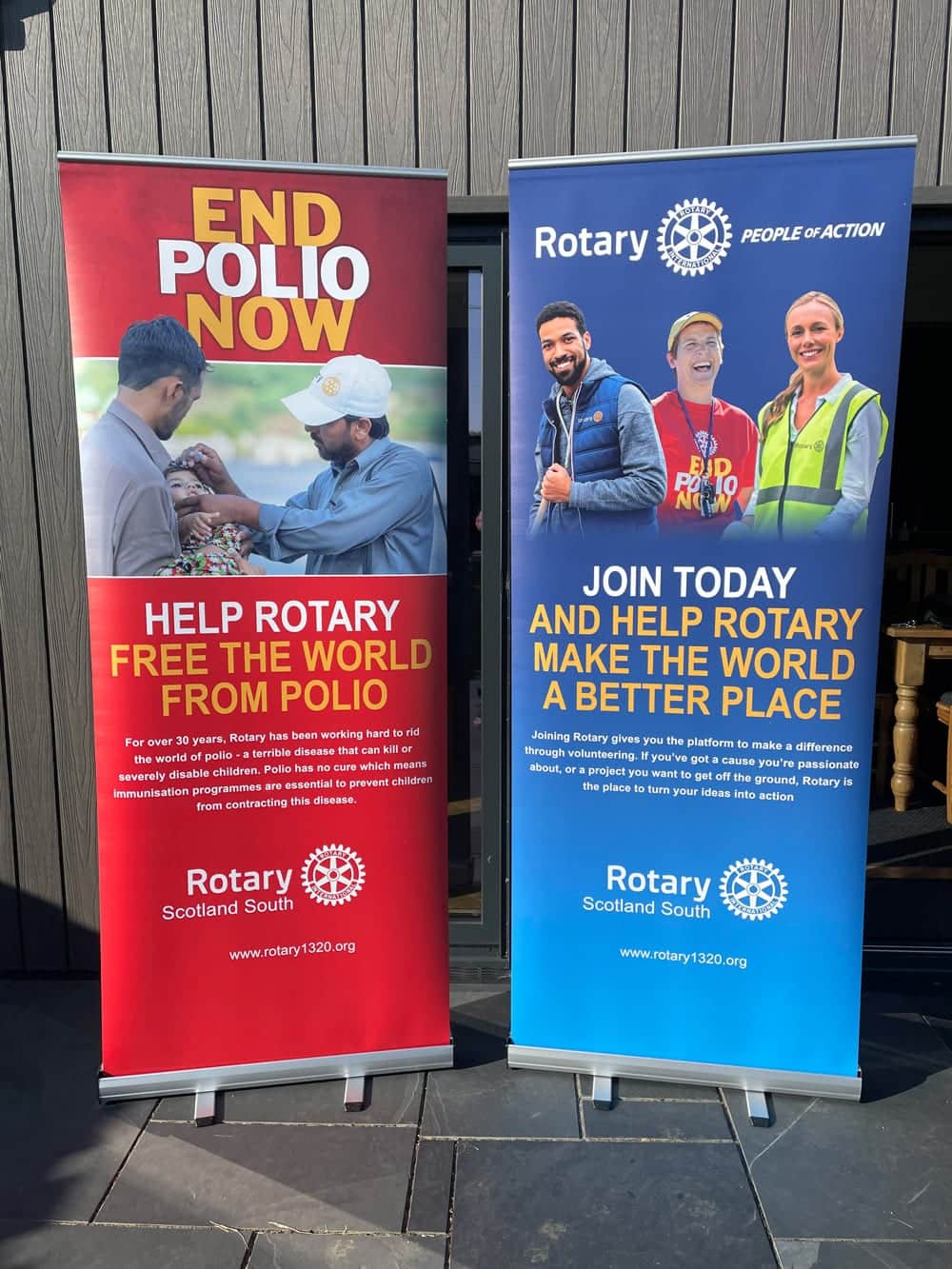 Two Rotary pull-up banners: End Polio Now in red and Join Rotary in blue