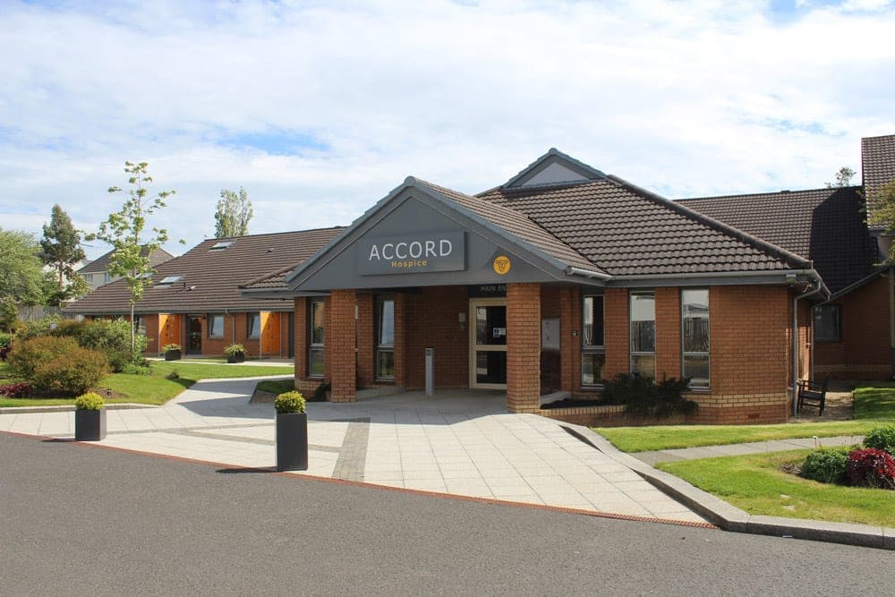 The ACCORD Hospice building with its new grey and yellow sign, after the rebrand