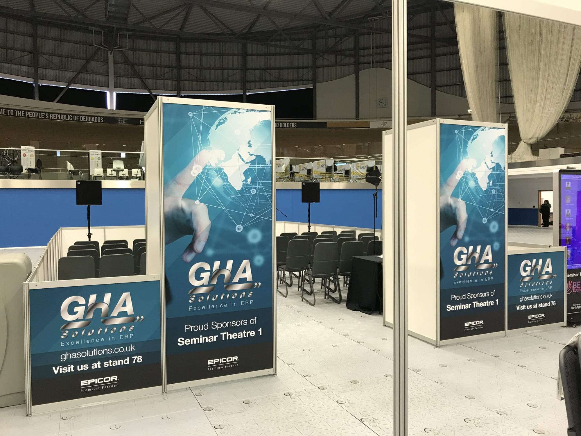 GHA Solutions banners beside a seminar theatre at an exhibition