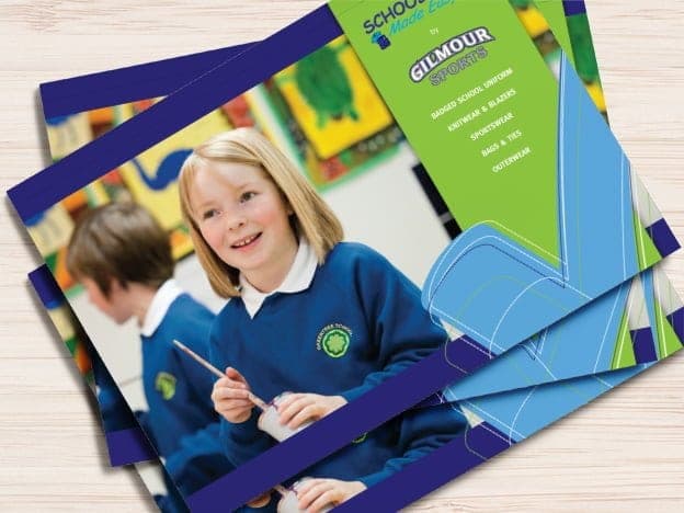 Gilmour Sports product brochures fanned out, cover showing a smiling schoolgirl