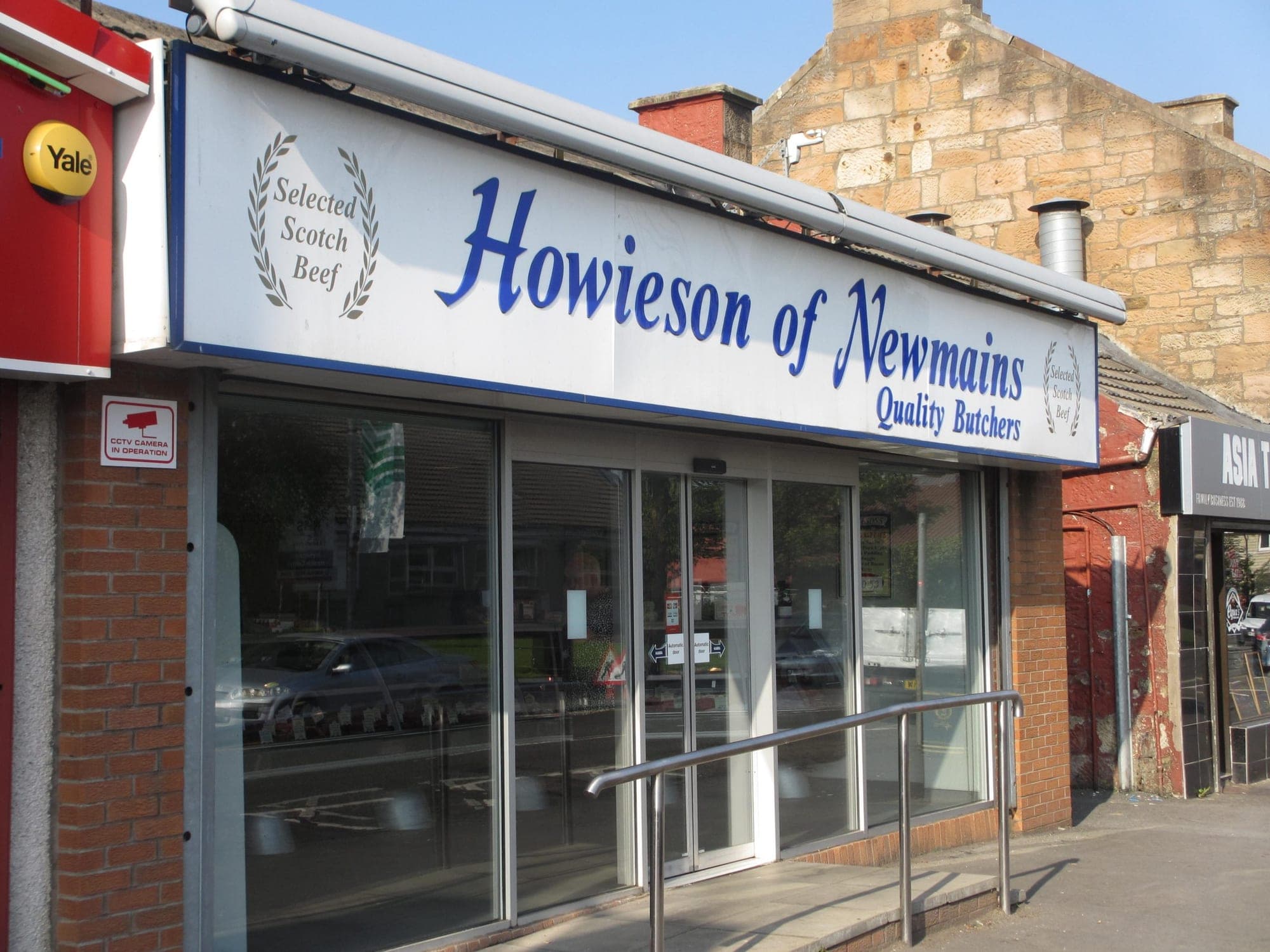 Howieson of Newmains shop front with the old white sign and blue lettering, before