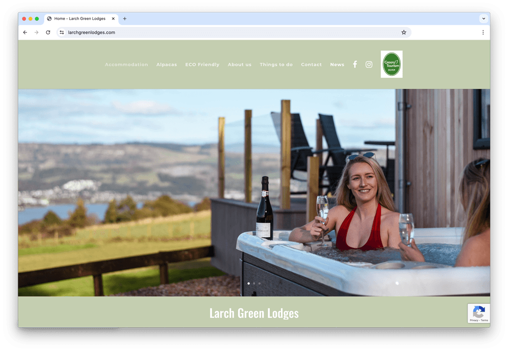 Larch Green Lodges website showing a hot tub with a view over the hills