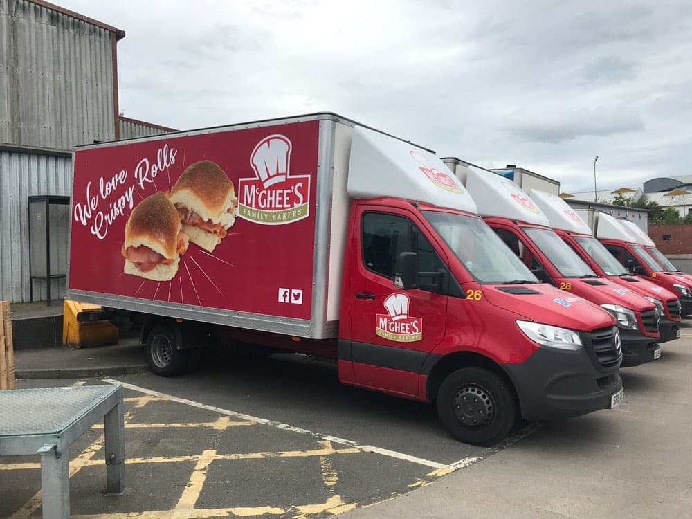 Red McGhee’s delivery lorry with a giant photo of crispy rolls and the words We love crispy rolls