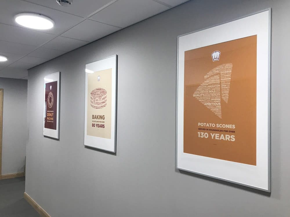 Framed McGhee’s heritage prints in an office corridor
