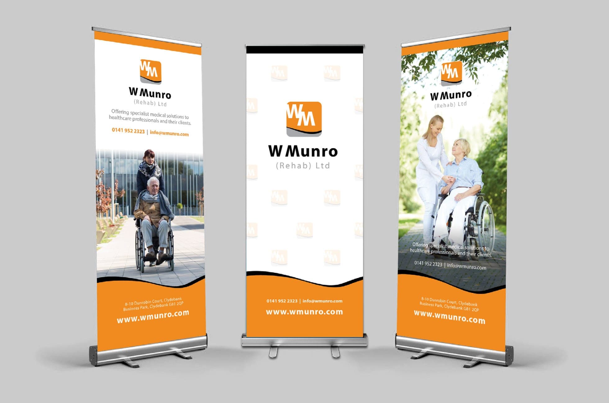 Three W Munro pull-up banners in orange and white