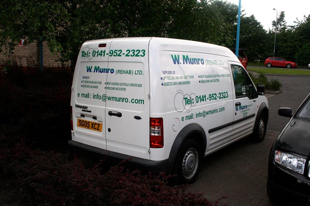 White W Munro van with plain green lettering, before the rebrand